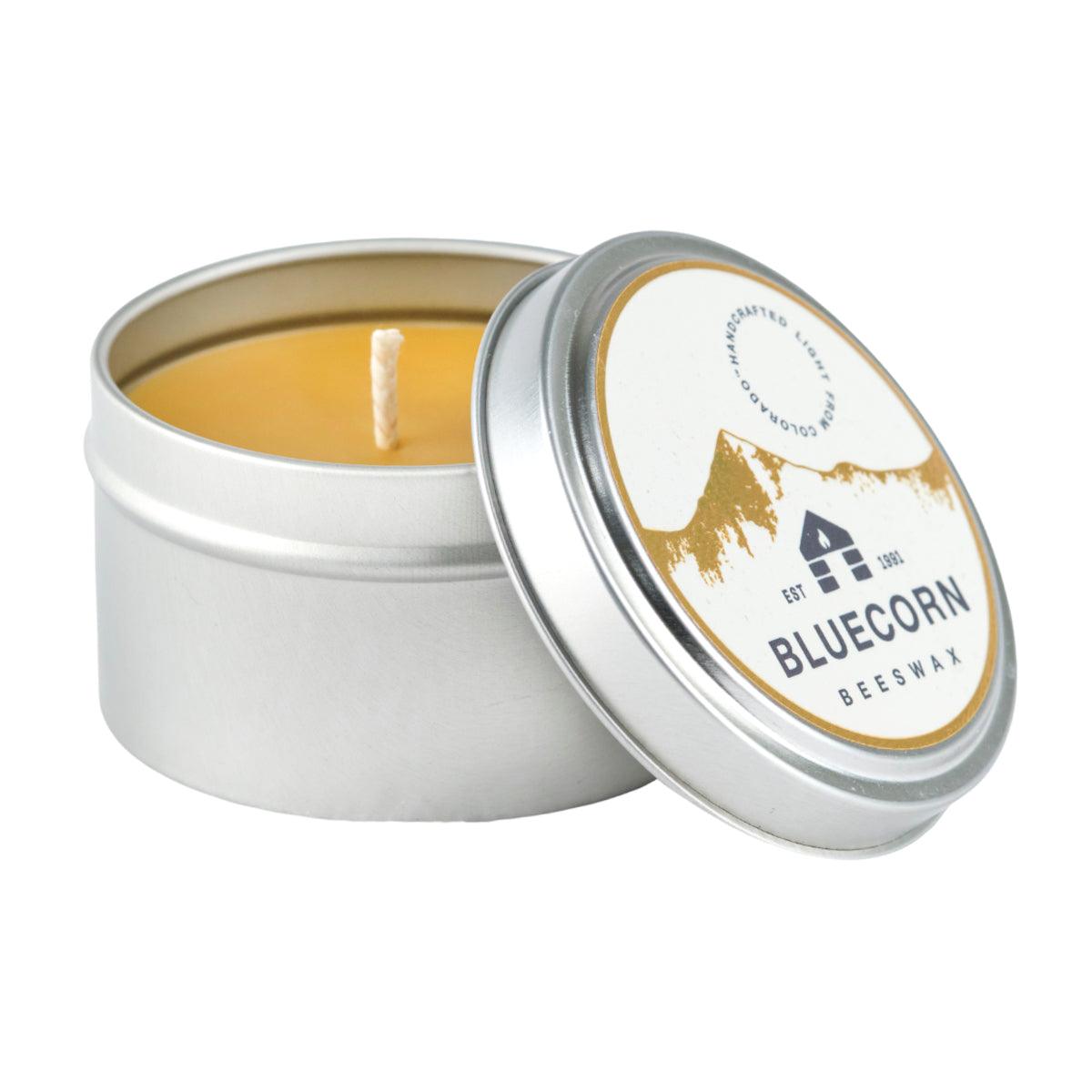 Bluecorn Beeswax Raw Beeswax Travel Tin 6oz Candle. Handmade in Montrose, CO. Paraffin and Lead free and made with a cotton wick. Burn time 30 hours. Candle Dimensions: 2.75in (dia.) x 1.75in (ht.). Wax is golden in color and packaging features a white and gold foil sticker with the Bluecorn Logo. Great For: Traveling, Camping, Hotel Rooms, Gifts. Metal tins are recyclable or can be repurposed and reused. We do not take the tins back after the candle is burned.