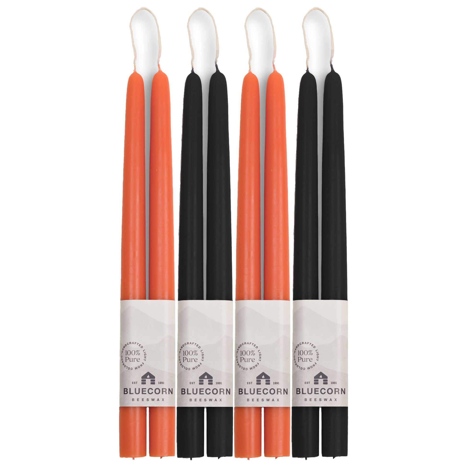 two pairs each of orange candles and black taper candles from bluecorn candles made with pure beeswax in colorado