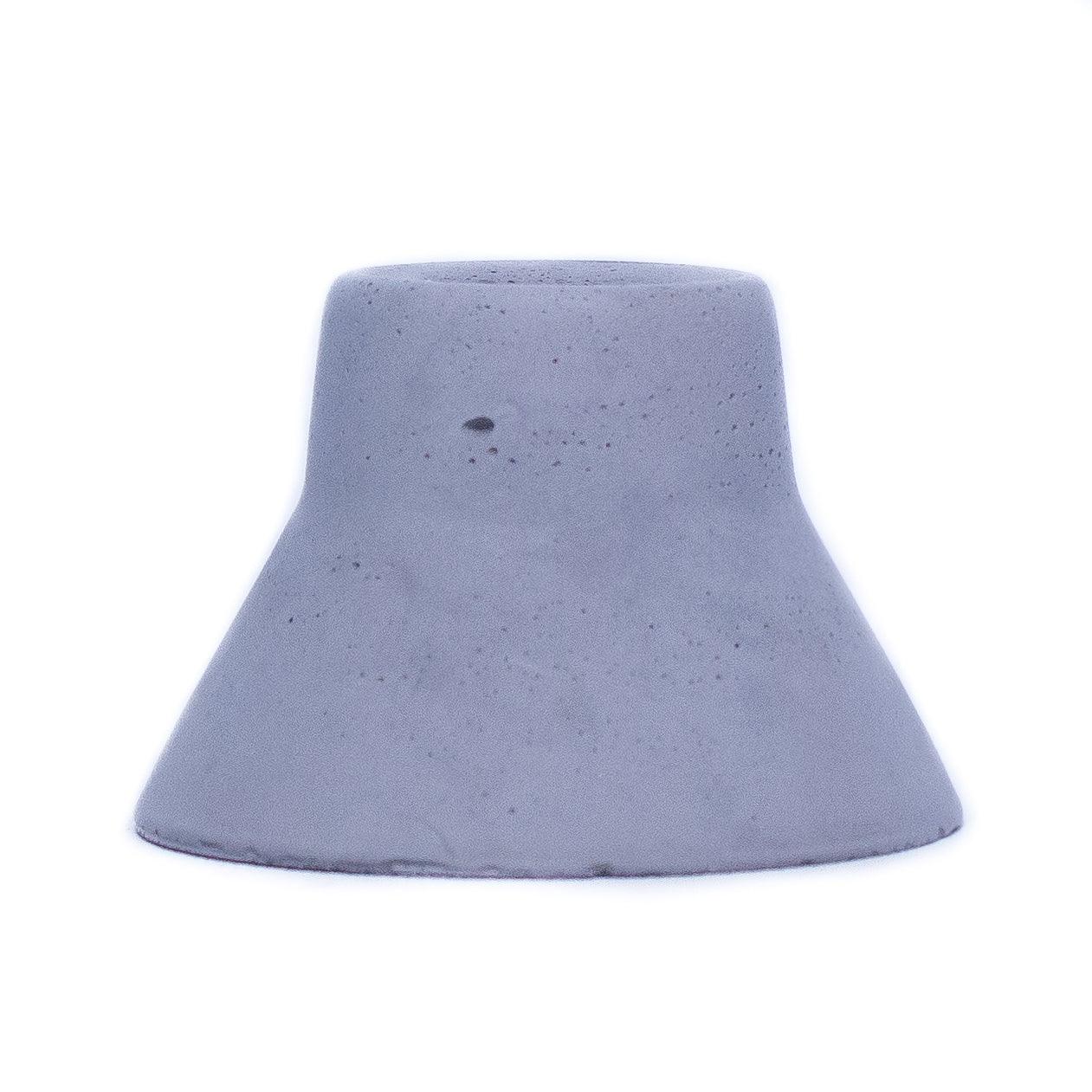 Charcoal colored concrete taper candle holder. Candle holder measures 3" at the base and narrows toward the top to fit a beeswax taper candle. 