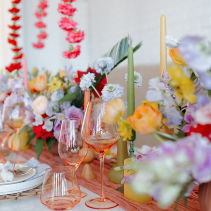 colorful spring table with green taper candle and pure beeswax taper candle