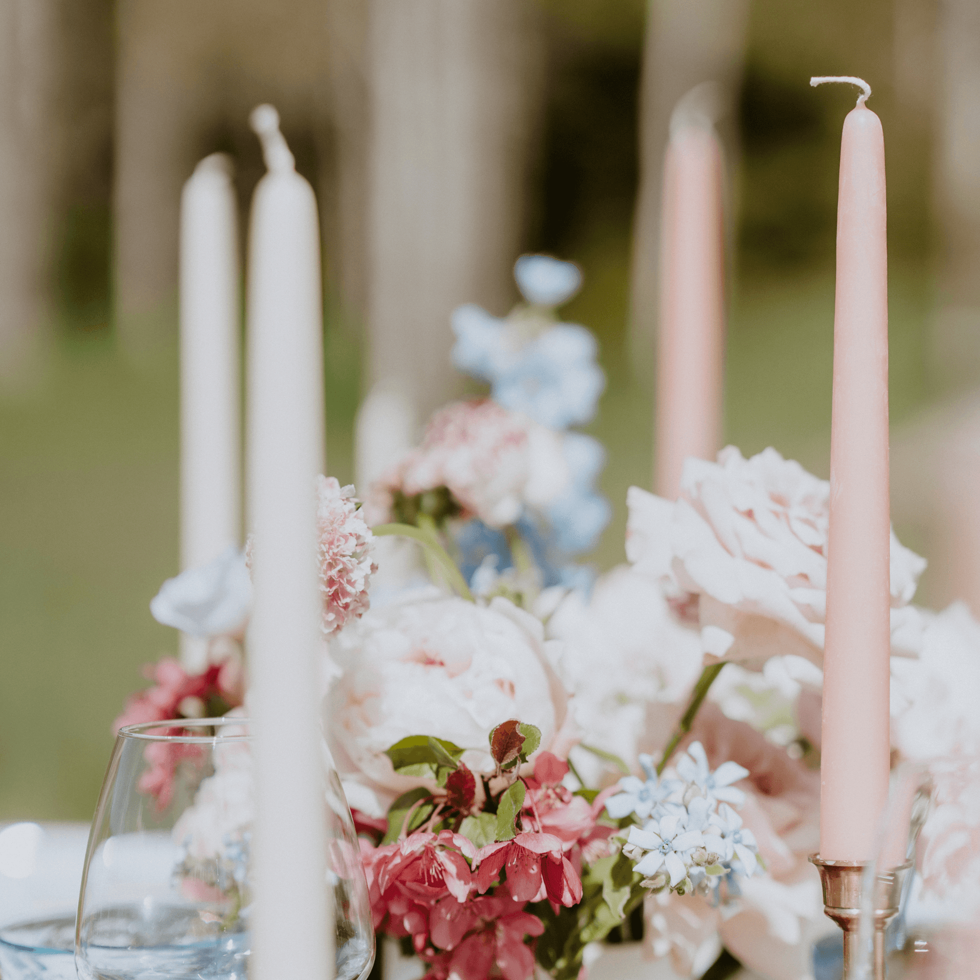 Bluecorn Beeswax hand-dipped taper candles in Ivory and Dusty Rose on a gorgeous outdoor wedding display in the mountains of Colorado