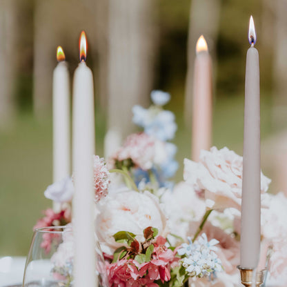 ivory white and dove grey beeswax taper candles on a wedding candle table